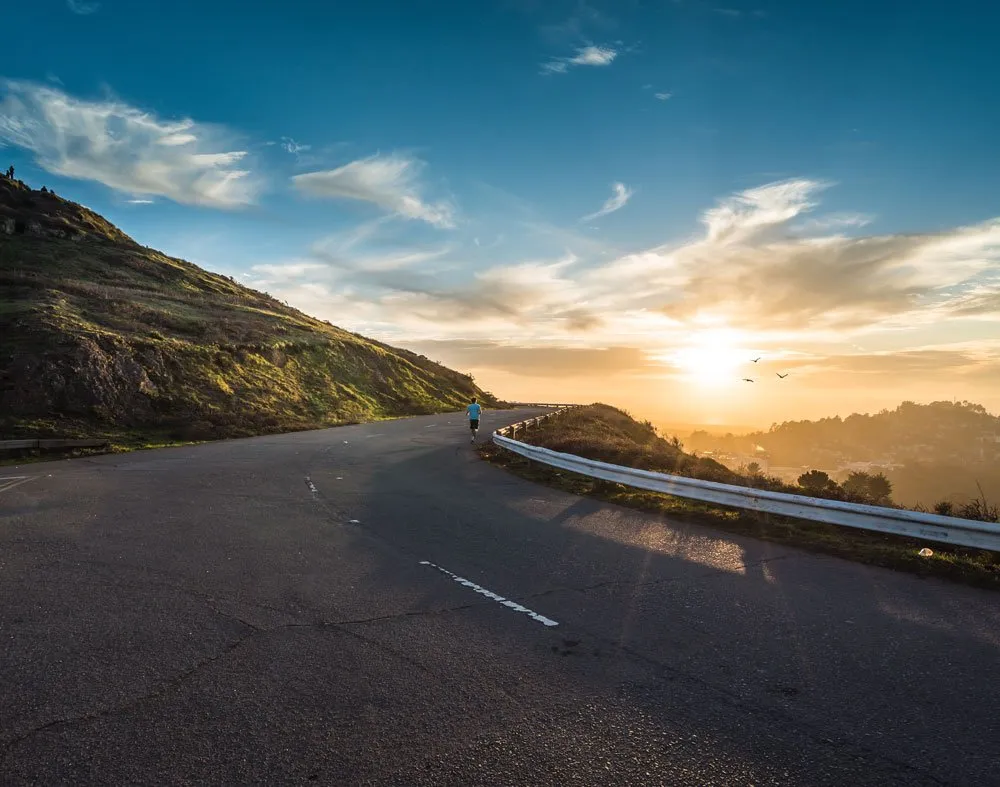 runner running up mountain road